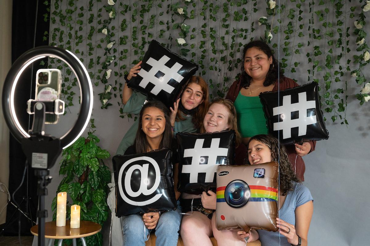 Group of students holding up social media tag posters at the Follow Fair at Berea College